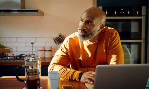 Person in kitchen with laptop
