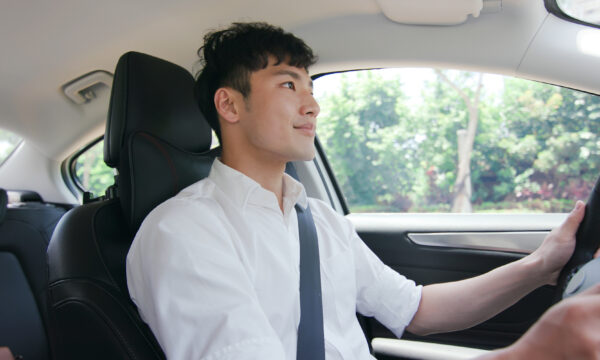 young man driving a car