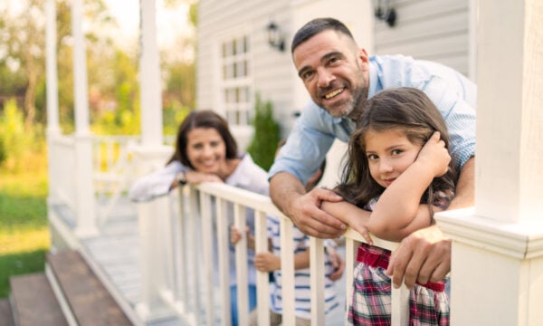 mom, dad and child on front porch