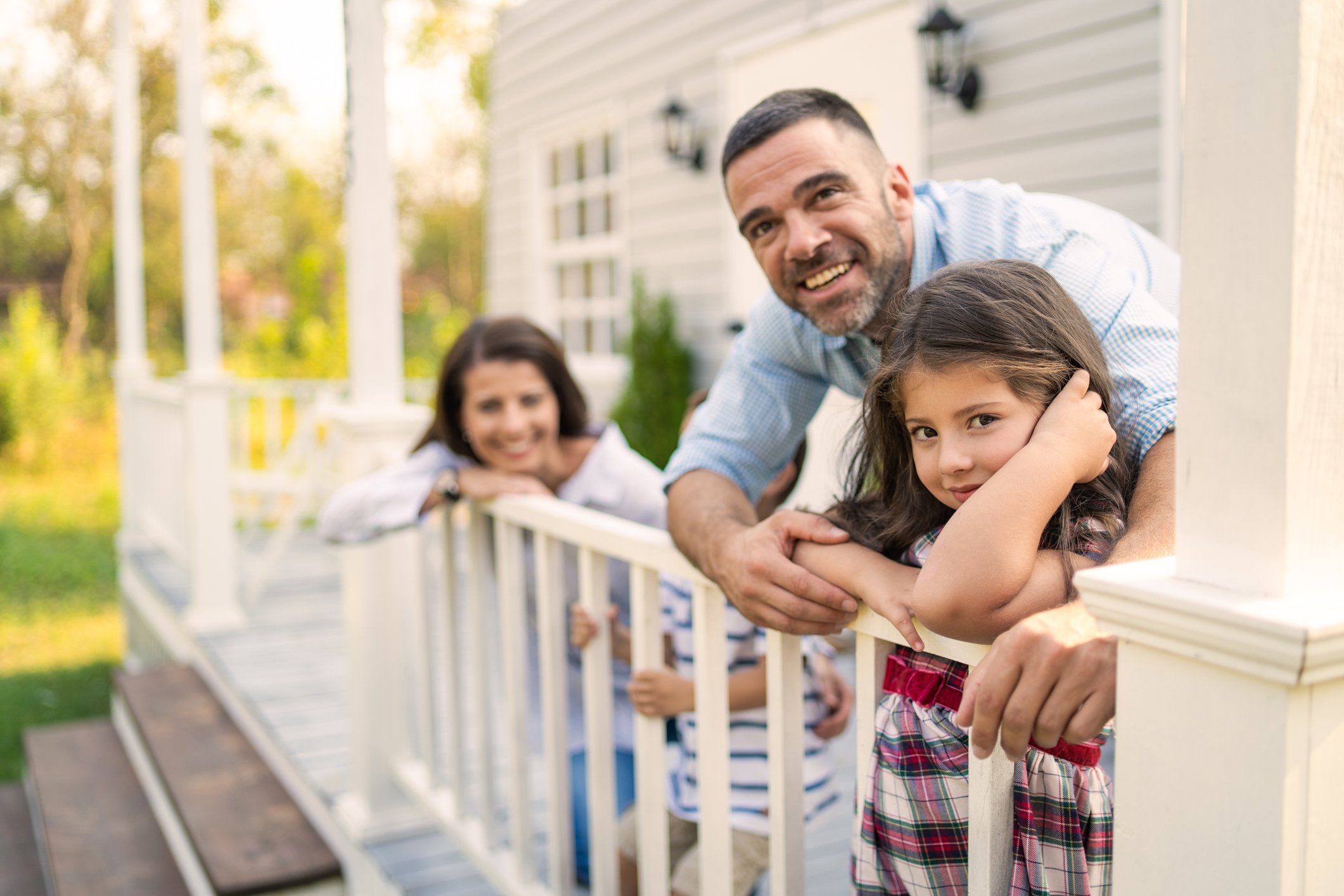 mom, dad and child on front porch