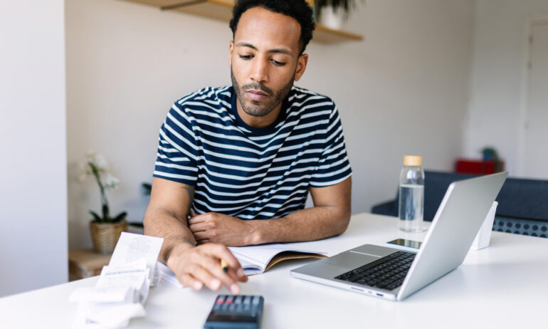 Person using calculator at desk