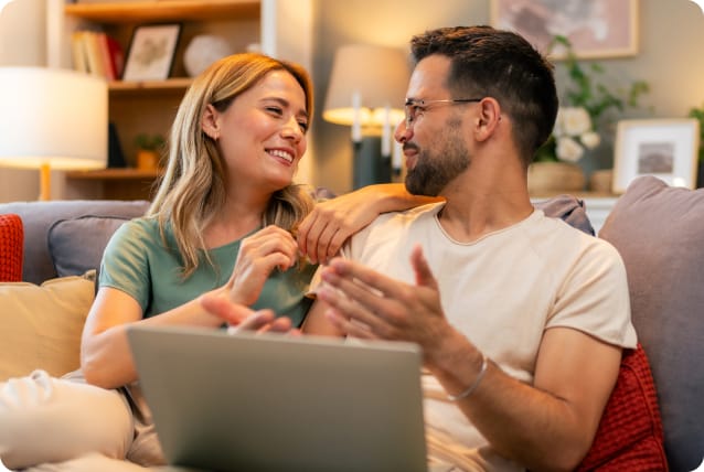 Two people sharing a laptop computer