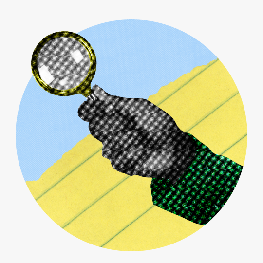 Hand holding magnifying glass