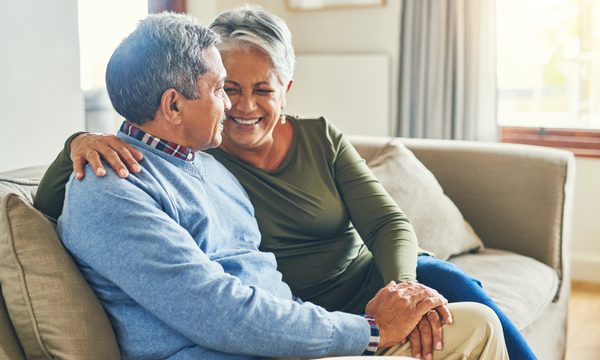 Older couple talking on sofa
