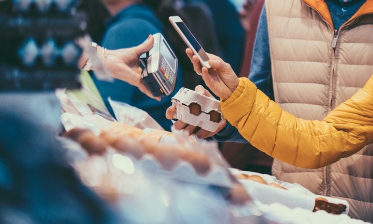 Shopper pays with digital wallet using their phone