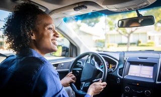 woman at the wheel of a car
