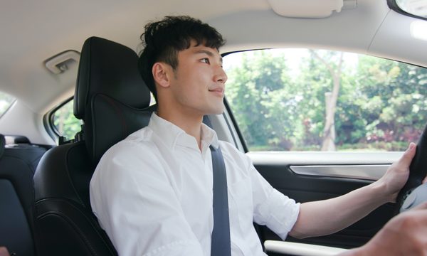 young man driving a car