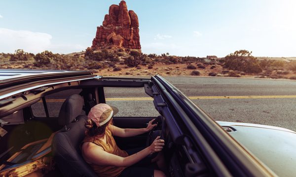 woman driving in arches national park