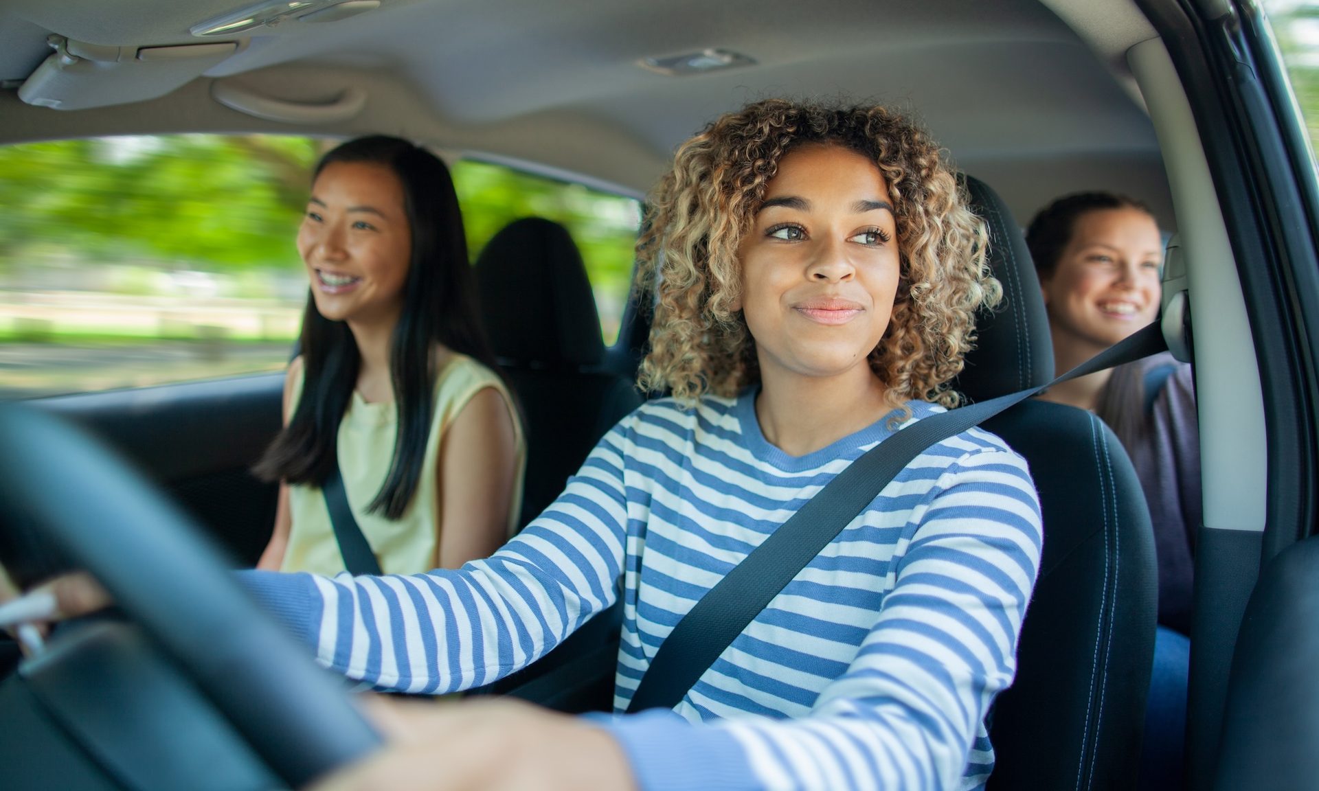 Group of female friends driving a car