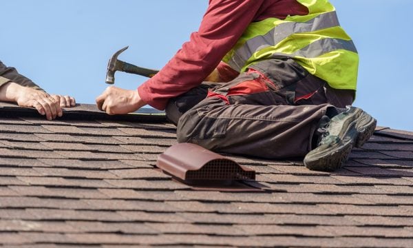 Contractor on top of house installing new roof